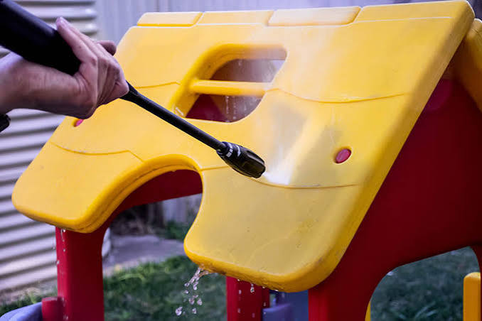 Pressure washing a school playground surface